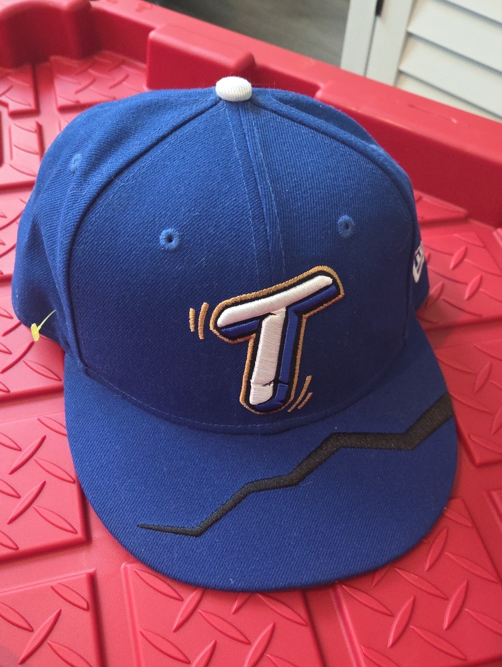 New Era Royal Blue Baseball Cap with White 'T' Embroidery and Black Visor Detail
